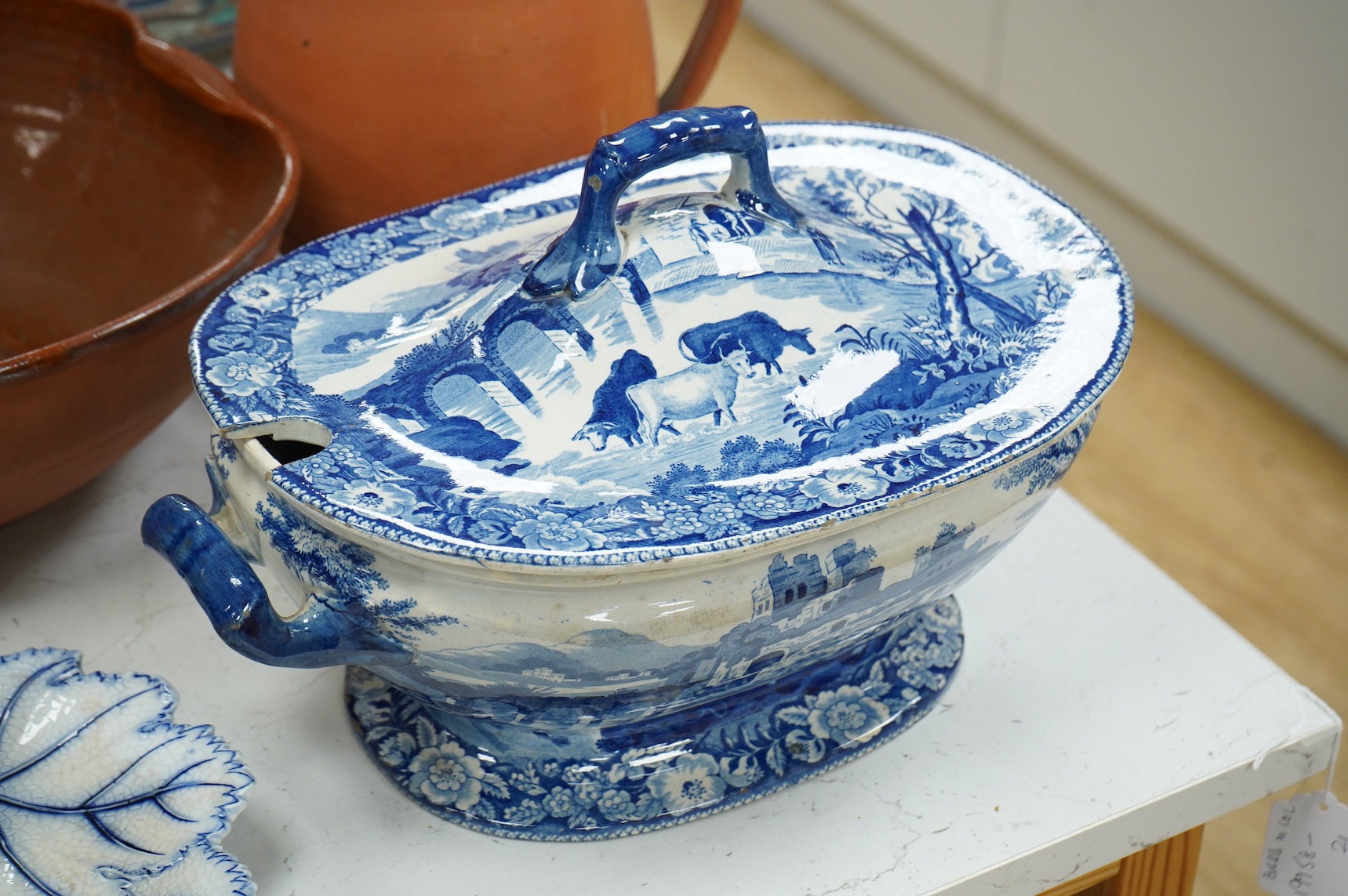 An early 19th century pearlware tureen, a pair of pearlware leaf dishes, a glazed earthenware jug and basin